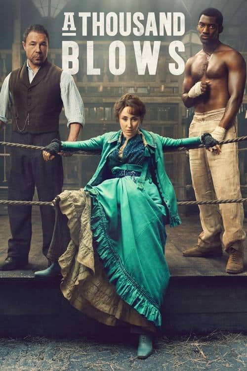 A publicity poster for "A Thousand Blows." In the center, a woman in a vivid teal Victorian-era dress and gloved hands is seated on the ledge of an elevated boxing ring. She is looking directly at the camera with a confident expression. Flanking her are two men standing behind the ropes. The man on the left wears a brown waistcoat and white shirt, holding his hands at his side. The man on the right is shirtless, muscular, has his hands wrapped, and holds a fighting stance. The text "A THOUSAND BLOWS" is centered at the top in large white letters. The setting is a rustic, wood-beamed boxing gym.
