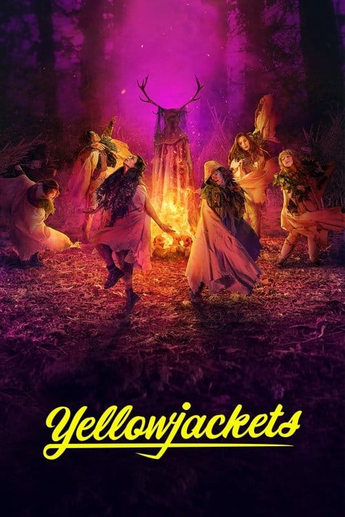 This is a vertical poster for the TV show "Yellowjackets." The scene is set at night in a dark forest, illuminated by a large campfire and a vibrant pink and purple glow. Several women, dressed in loose, ragged light-colored clothing and a few animal skins, are depicted in a ritualistic dance around the fire. One woman in the center has prominent deer antlers emerging from her head and wears a sheer veil, standing over the fire. Other women crouch or are in motion, some with faces obscured by cloaks. The ground is dark, leafy forest floor. At the bottom, the title "Yellowjackets" is written in a bold, yellow script font with a tail on the "s."