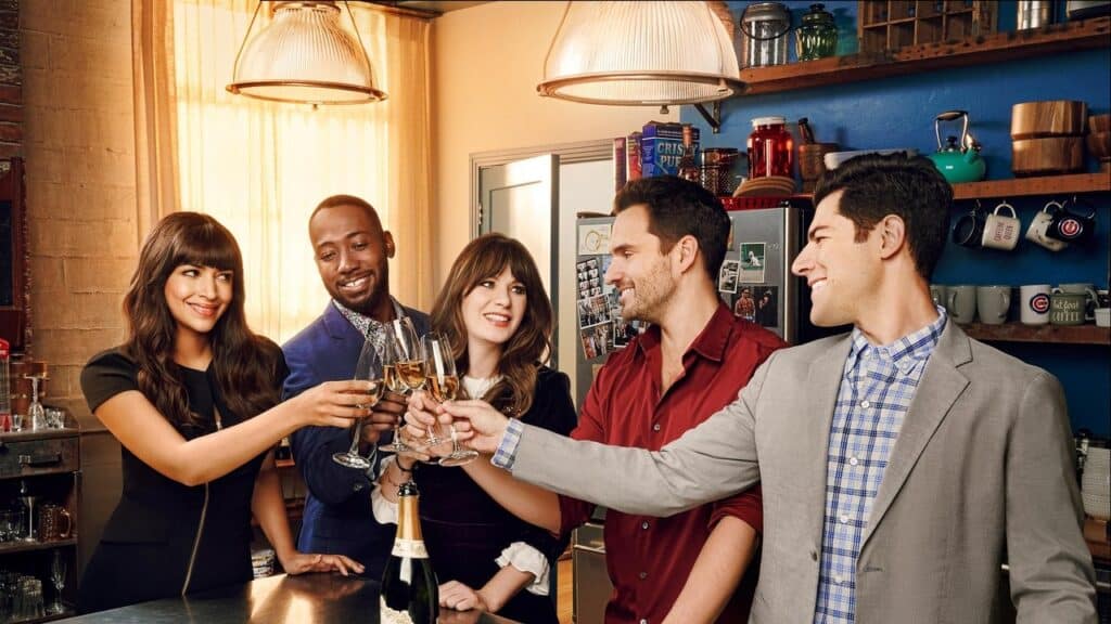 Group of close friends toasting together in a cozy apartment kitchen, capturing the warmth and humor of found family shows like New Girl.
