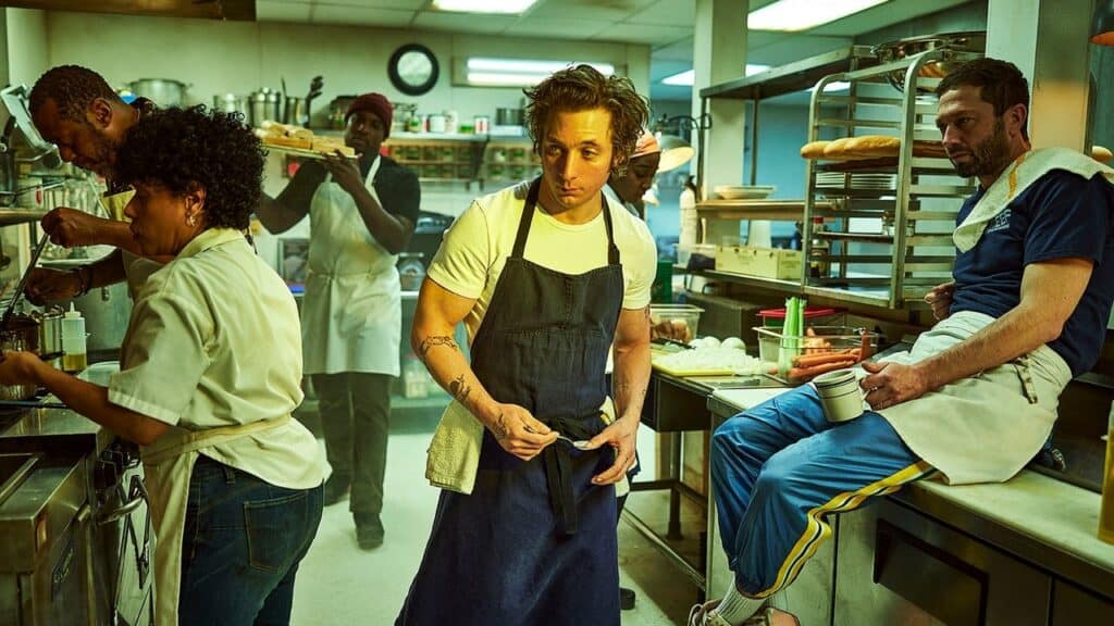 Intense kitchen scene with chefs working under pressure during a chaotic service, capturing the tension and urgency of high stress drama shows like The Bear.