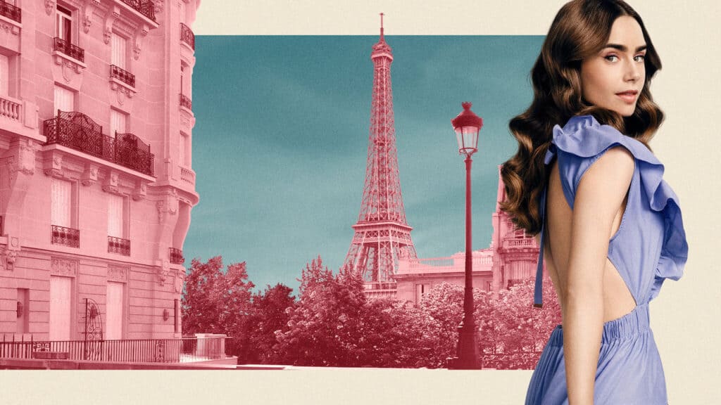 A woman in a blue dress standing near Parisian architecture with the Eiffel Tower behind her.