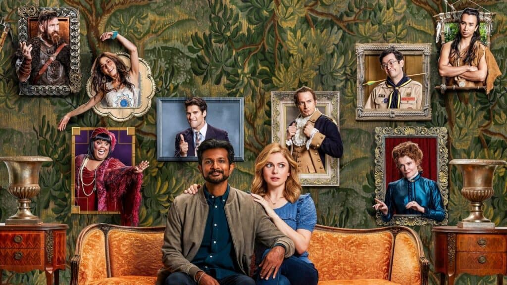 The living couple sit on a couch while framed portraits of the ghosts hang behind them on a patterned wall, visually surrounding them with the house’s past residents.