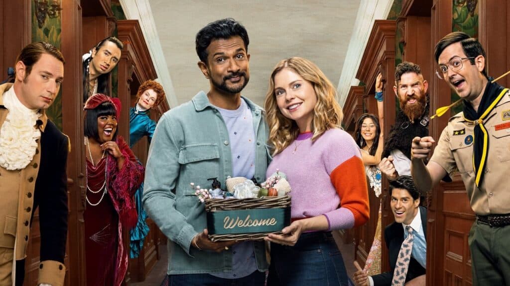 The living couple hold a welcome basket as the ghosts peer in from the hallway, creating a playful and crowded group scene.
