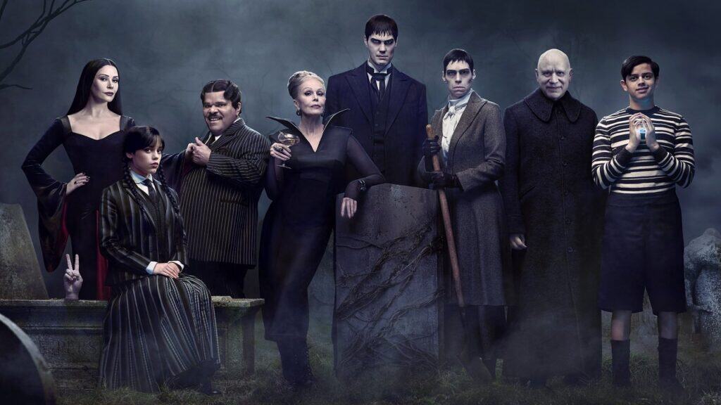 The Addams Family standing together in a dark, gothic setting from the Netflix series Wednesday