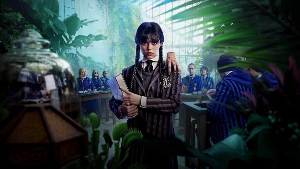 Wednesday Addams holding a book in a greenhouse classroom surrounded by other Nevermore students
