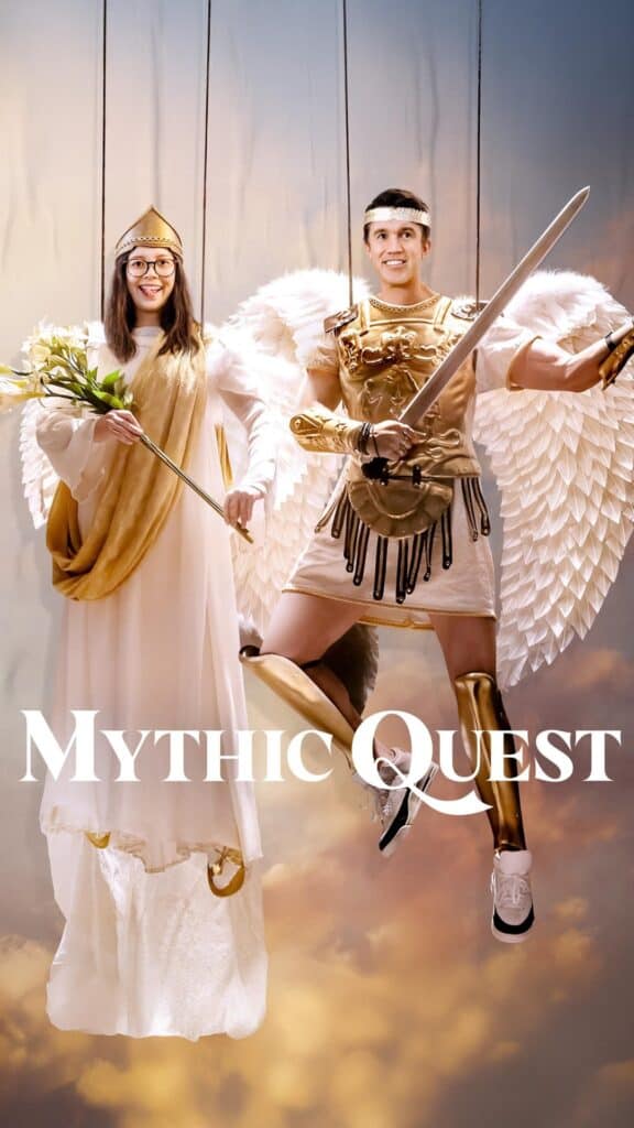 Mythic Quest promotional image showing two characters dressed as angelic figures with wings and armor against a dramatic fantasy-inspired background.