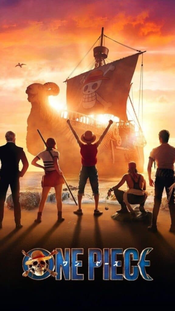 One Piece live-action poster showing the pirate crew standing on a beach at sunset with a ship bearing a skull flag in the background.
