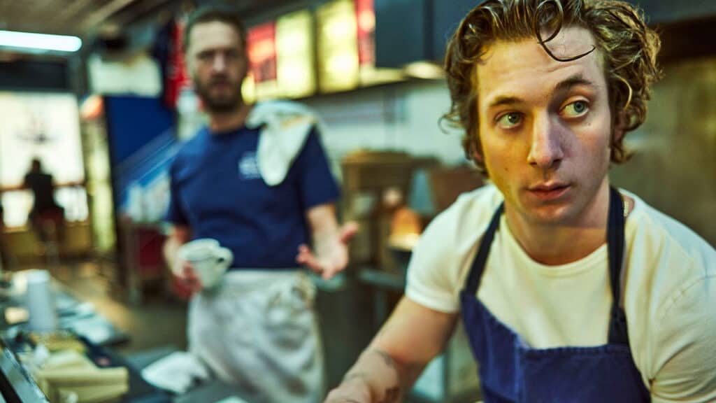 Close up of Carmy looking overwhelmed while working in the chaotic restaurant kitchen on The Bear