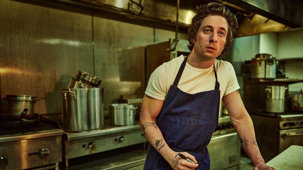 Carmy leans against the counter in a quiet restaurant kitchen after a stressful shift on The Bear