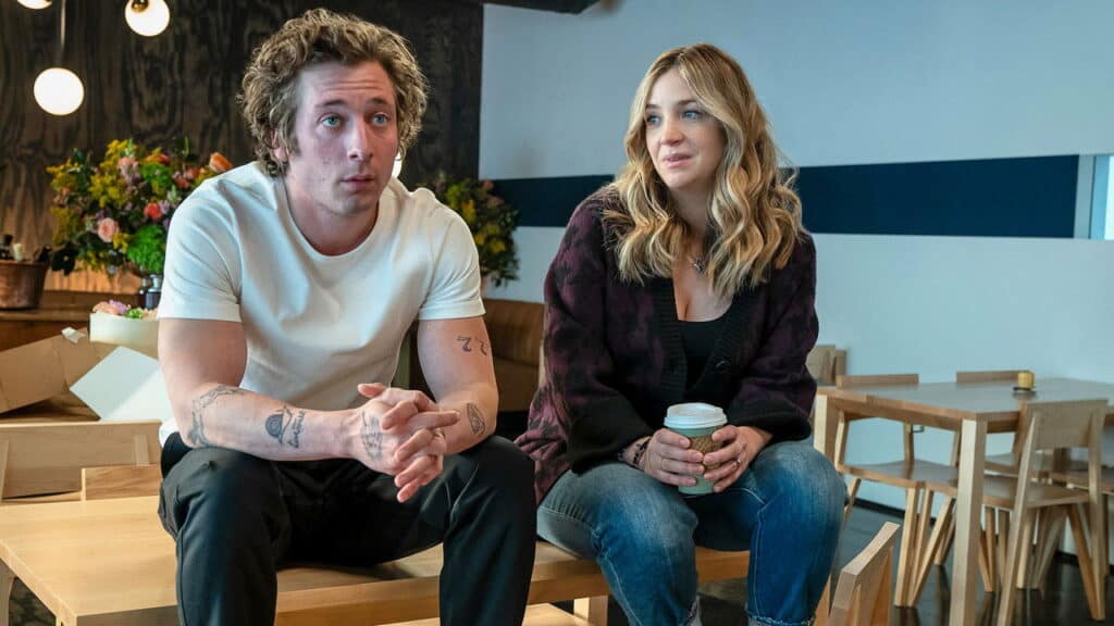 Carmy and Sydney sit together holding coffee while discussing the future of the restaurant on The Bear