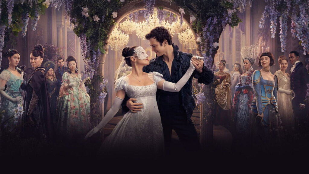 A couple dances closely beneath chandeliers at a lavish masked ball, surrounded by guests in elaborate Regency costumes watching from the background.