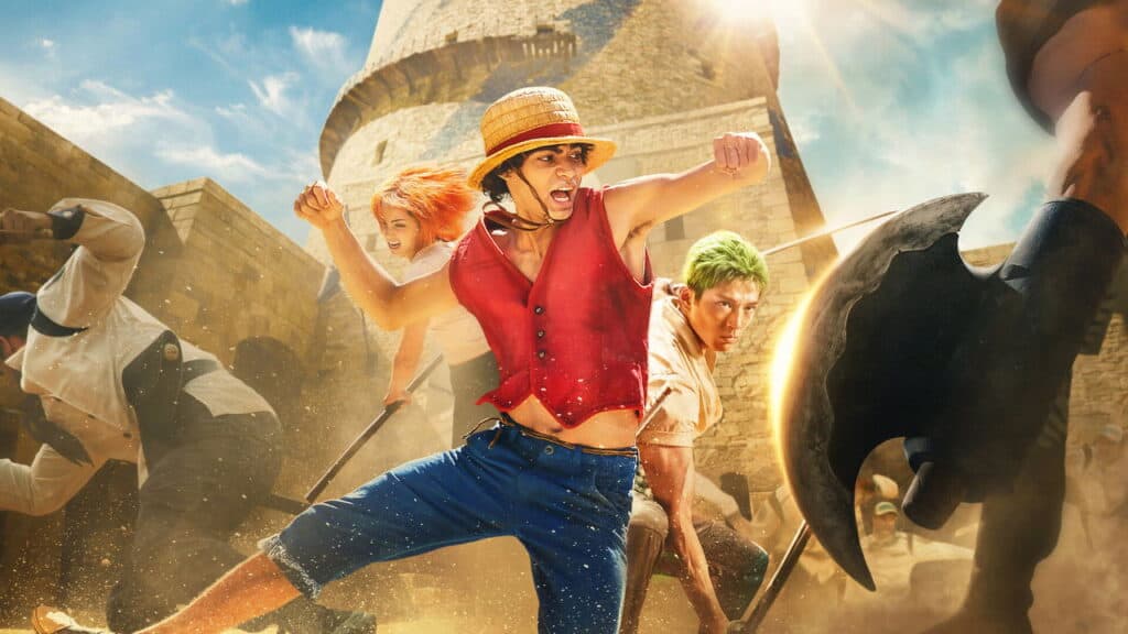 One Piece live action characters fighting enemies in a stone courtyard with dust flying during intense combat