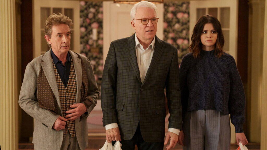 Steve Martin, Martin Short, and Selena Gomez stand together during a serious moment in Only Murders in the Building.