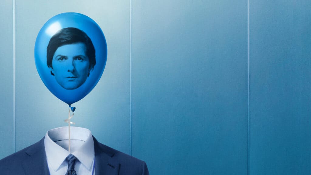 A man in a business suit with a blue balloon for a head symbolizing emotional detachment and identity control in Severance