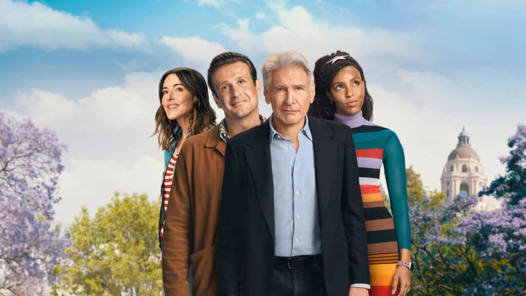 Four adults stand side by side in a park setting, looking forward with thoughtful expressions that suggest reflection and emotional connection.