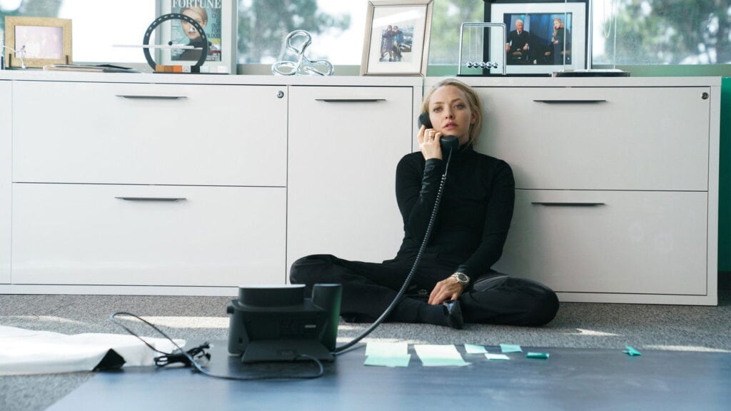 Amanda Seyfried as Elizabeth Holmes sits on the office floor during a tense moment in The Dropout on Hulu.
