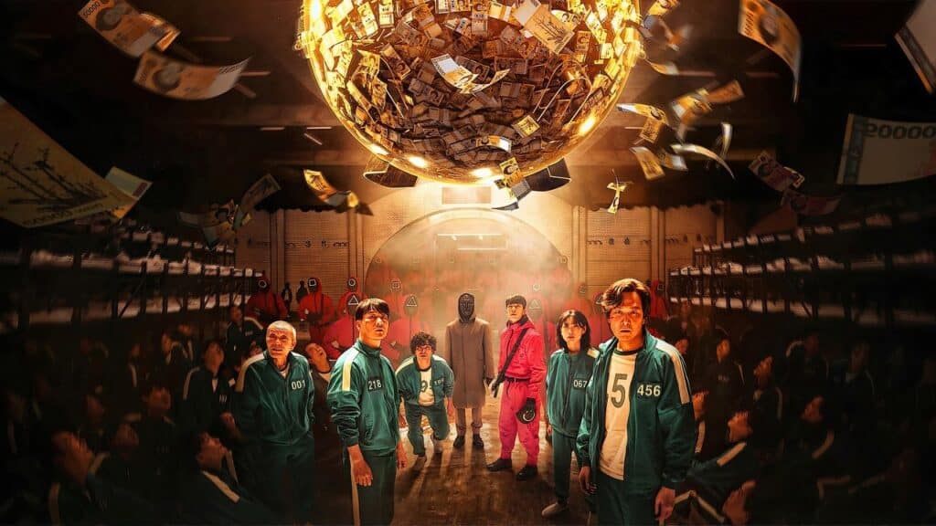 Contestants look up at a giant glowing sphere filled with money suspended above them, representing the life-changing reward that drives the brutal competition.