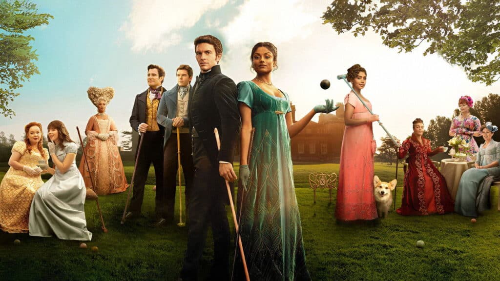 Bridgerton ensemble cast in vibrant Regency gowns and formalwear standing on an estate lawn, emphasizing the show’s romantic tone and stylized aesthetic.