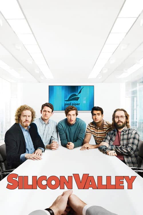 Promotional image for Silicon Valley featuring the main cast seated at a conference table in a bright Pied Piper office