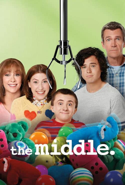 A promotional poster for The Middle showing the Heck family peering out from behind a pile of stuffed animals while a mechanical claw hangs above Brick's head.
