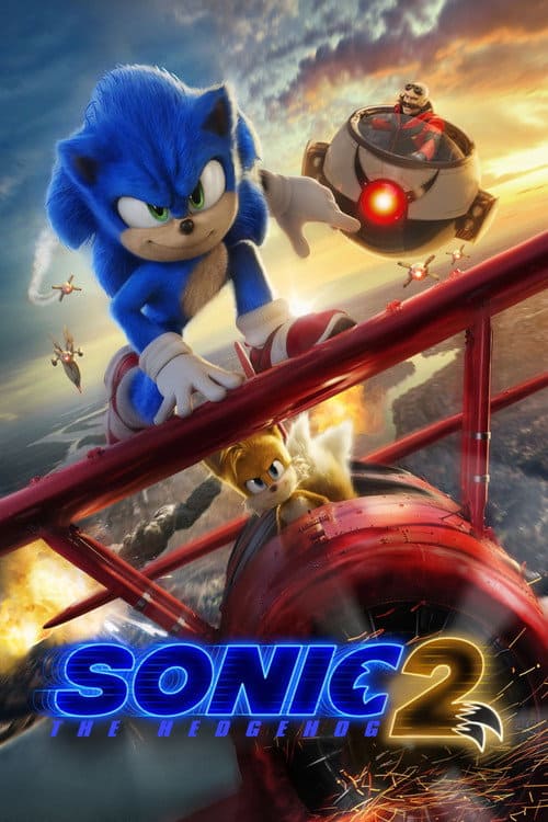 Action shot from Sonic the Hedgehog 2 featuring Sonic standing on top of a red biplane piloted by Tails as they soar through the sky with Dr. Robotnik’s drones in pursuit.